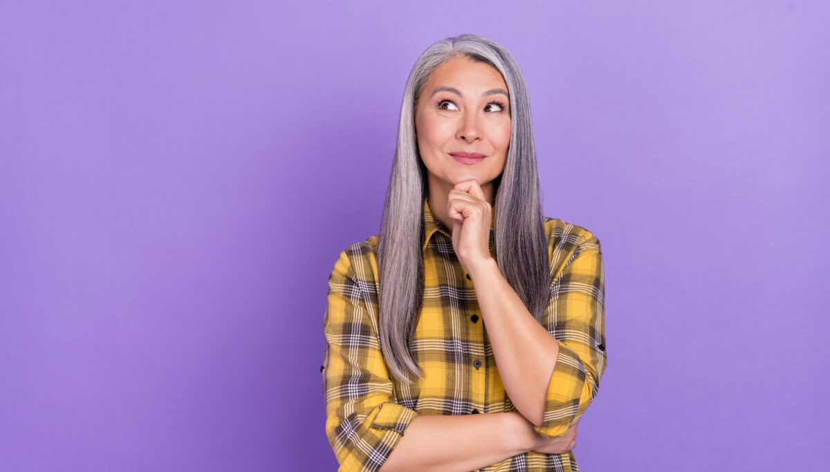 Photo of senior lady wondered look empty space think idea isolated over violet color background.