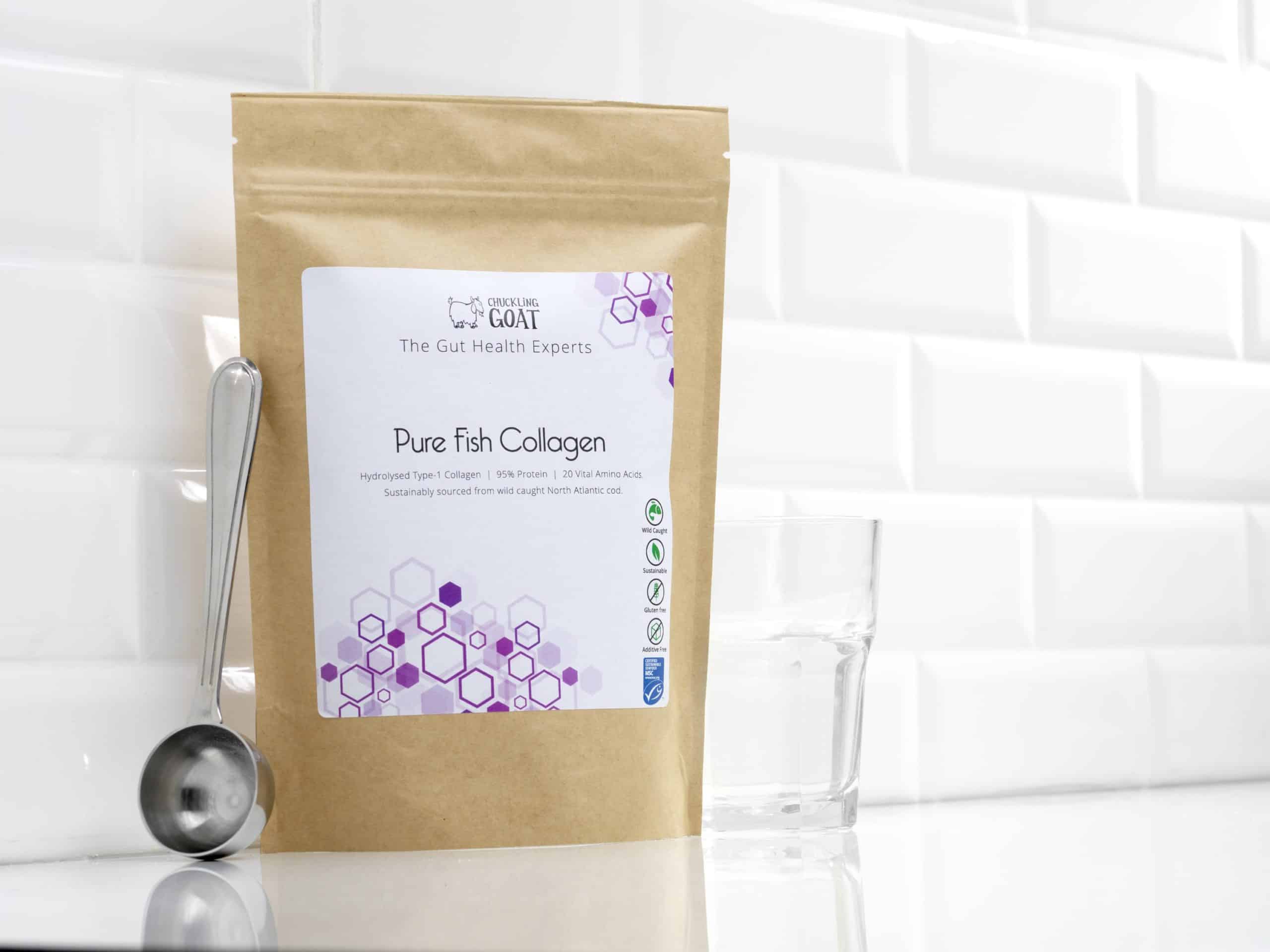 Package of Chuckling Goat Pure Fish collagen next to an empty measuring spoon and glass on a countertop.