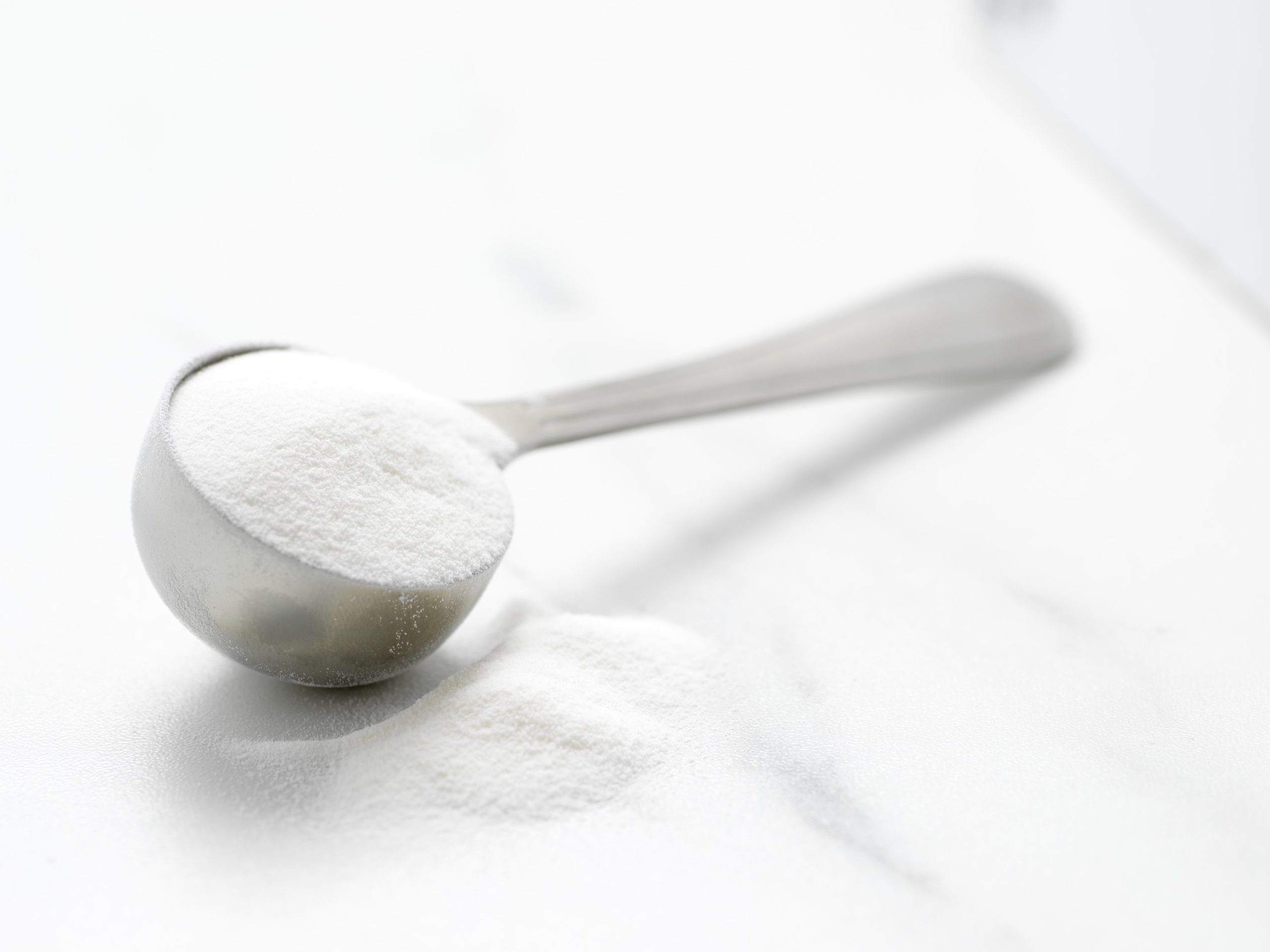Measuring spoon full of fish collagen powder