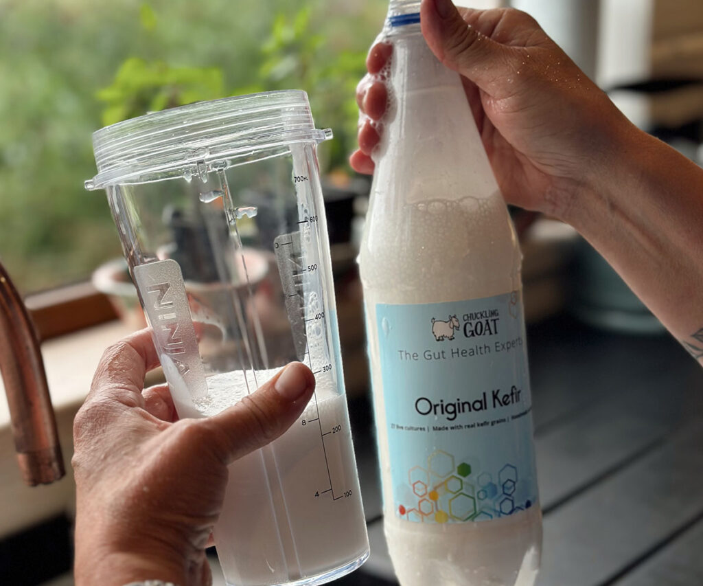 Image of Chuckling Goat Original Kefir and measuring cup held by Shann Jones.