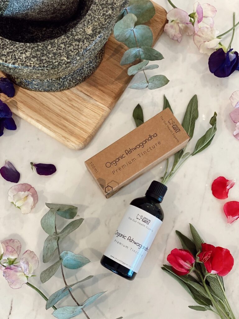 Image of Chuckling Goat Organic Ashwagandha Premium Tincture on background with leaves.