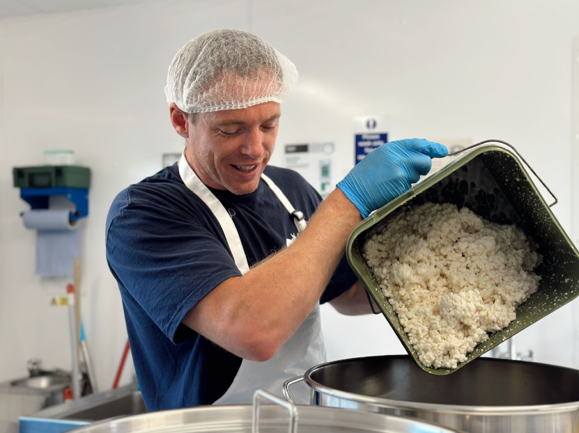 Image of Iestyn, Chuckling Goat staff member, making kefir with real, live kefir grains.
