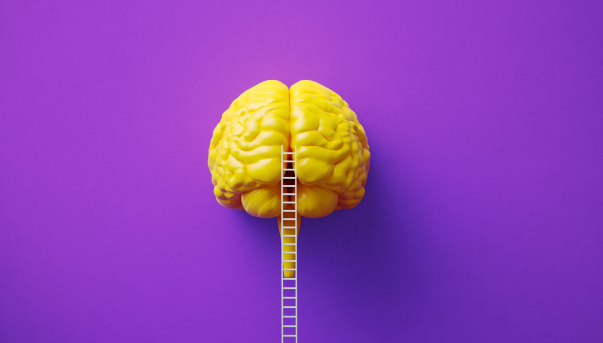 White ladder leaning onto a yellow coloured brain object before purple background. Horizontal composition. Mental health concept.