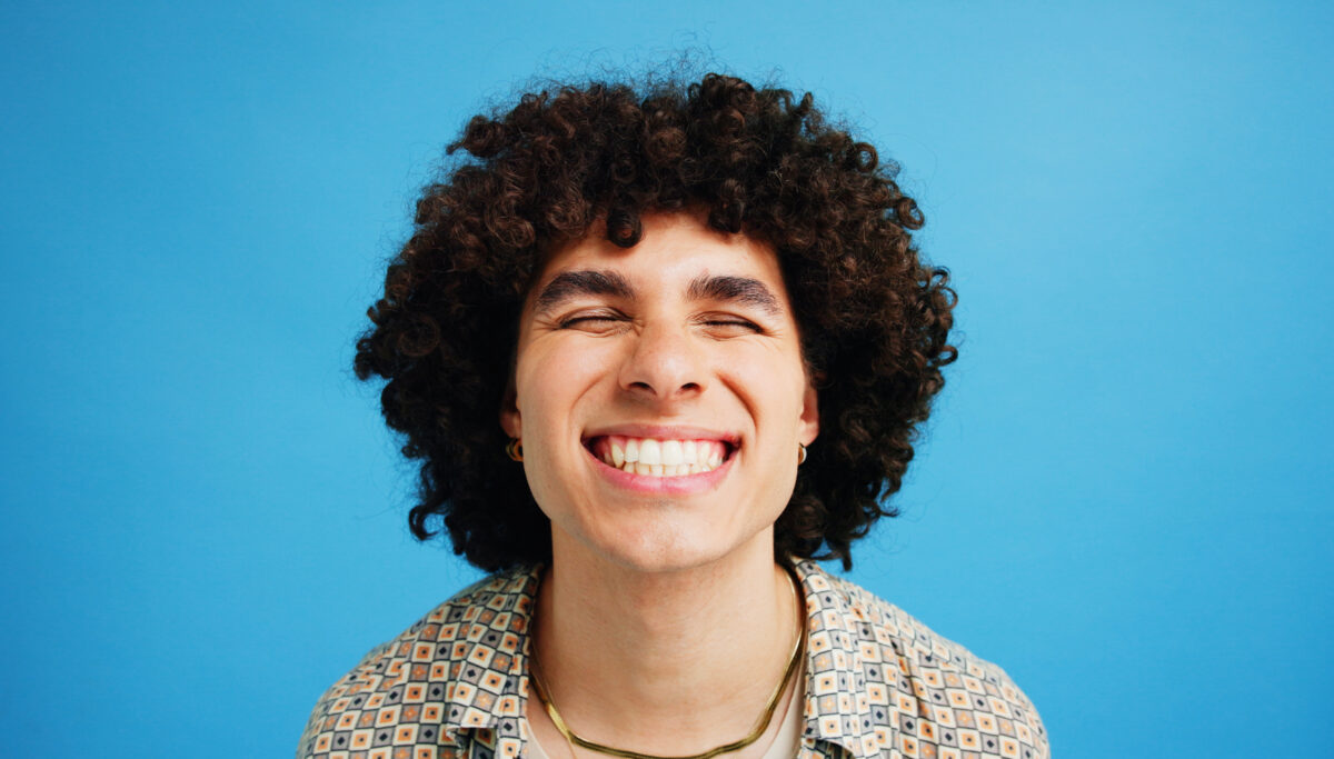 Studio, man and wellness with smile for dental, teeth whitening and confidence. Mockup space, happy, male person, blue background