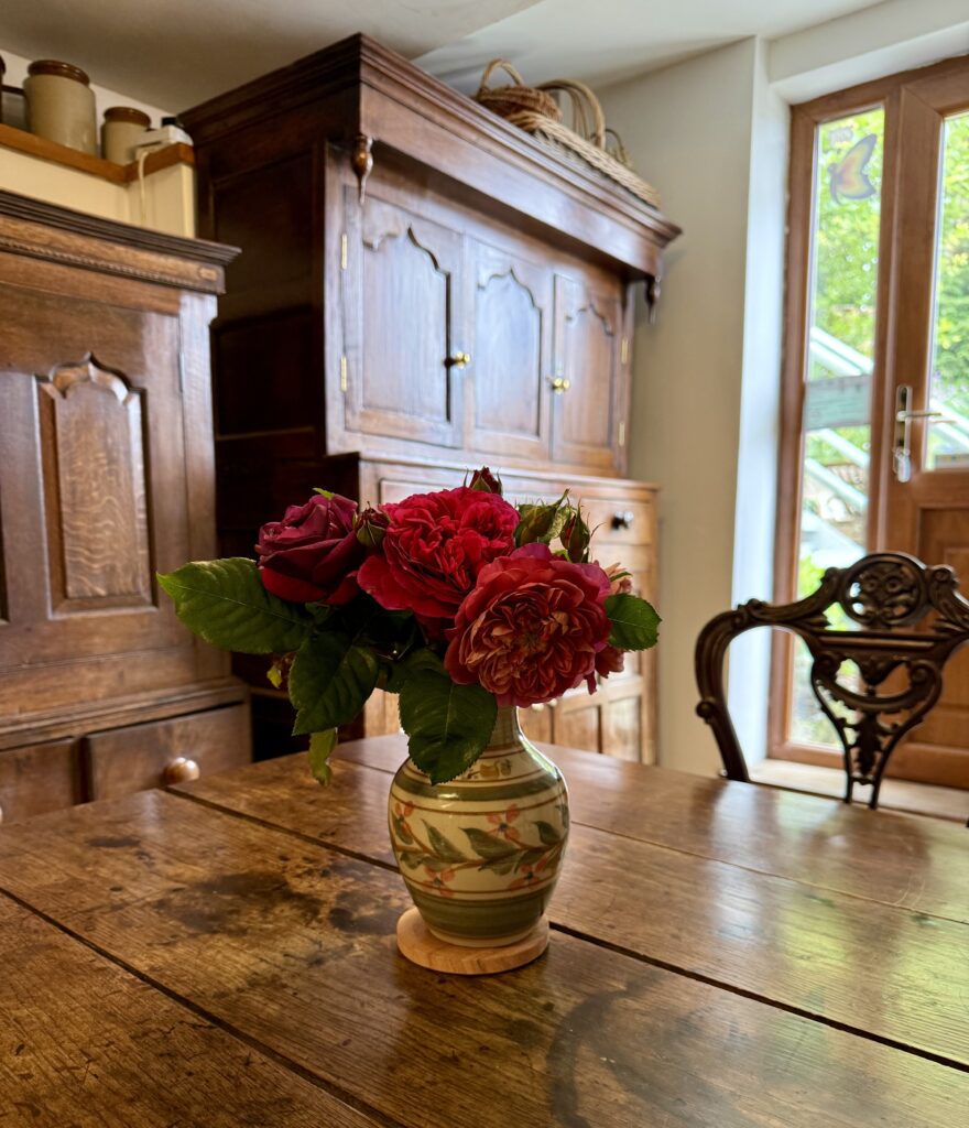 Image of flowers on wooden table in Shann Jones's office