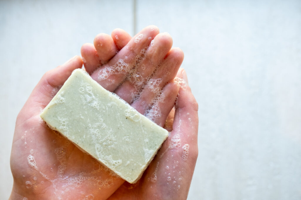 Image of Chuckling Goat Break Out Soap lathered in hands.