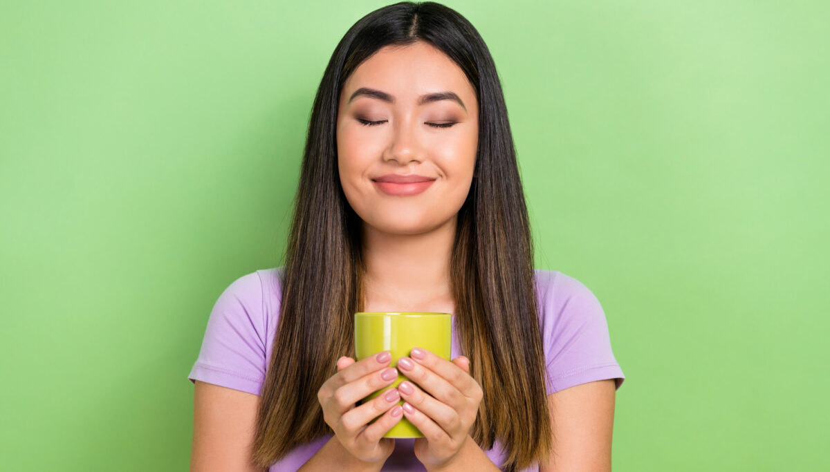 Photo of girl wear purple t-shirt hold cup fresh aroma coffee drink relax time isolated on green color background.