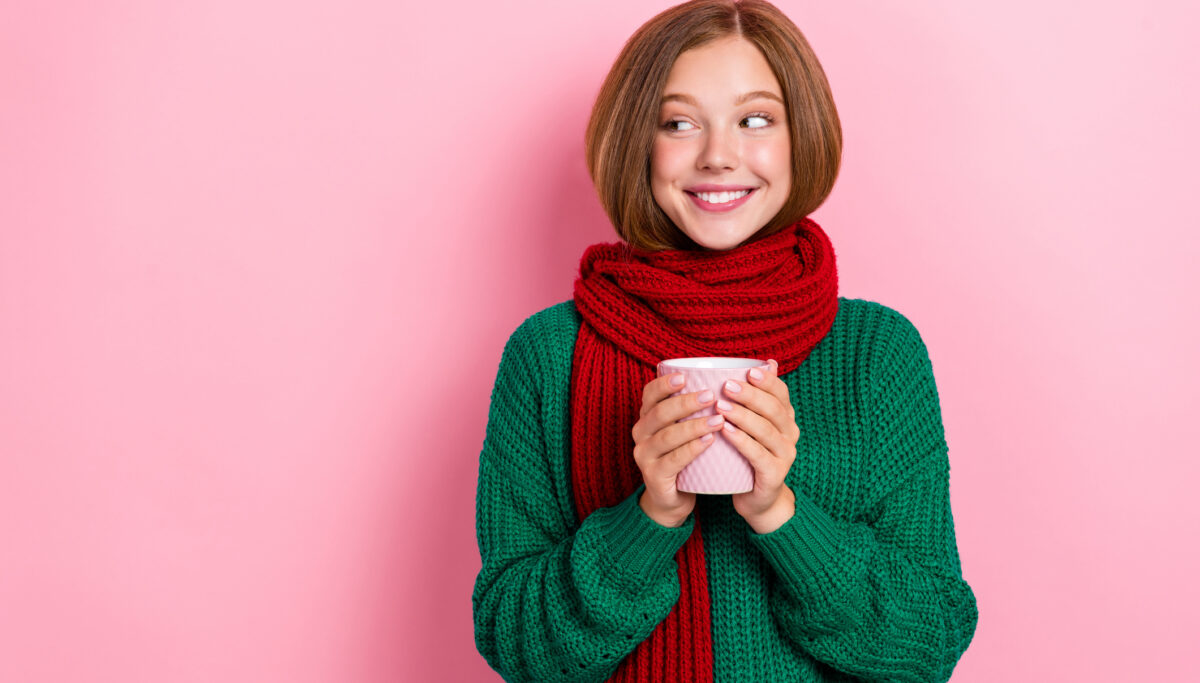 Photo of girl dressed knitted pullover arms red scarf drinking hot tea looking empty space isolated pink color background.