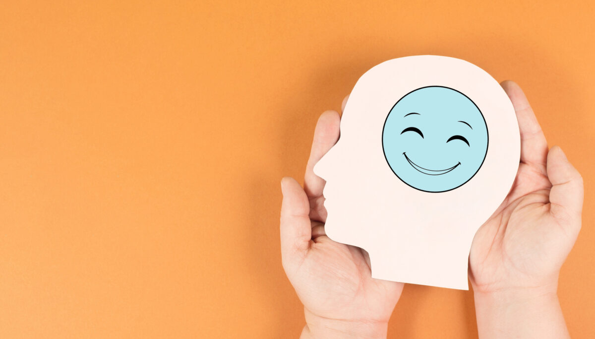 Holding a smiling happy face in the hands, positive emotions, good customer feedback