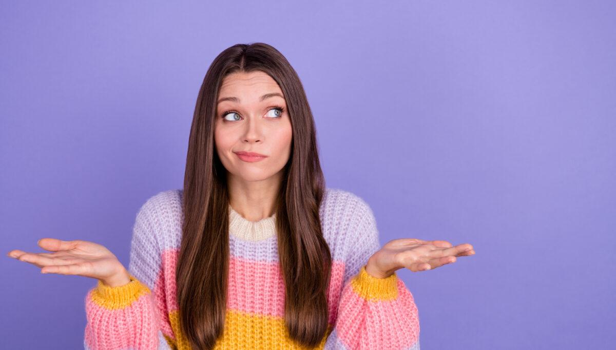 Photo of girlish gorgeous adorable girl with long hairdo dressed striped pullover confused questioned isolated on purple color background.