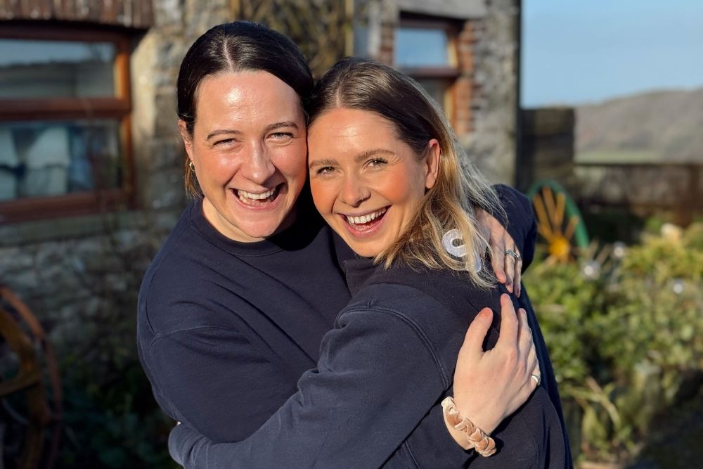 Two smiling women, happy, hugging, fresh air and sunshine