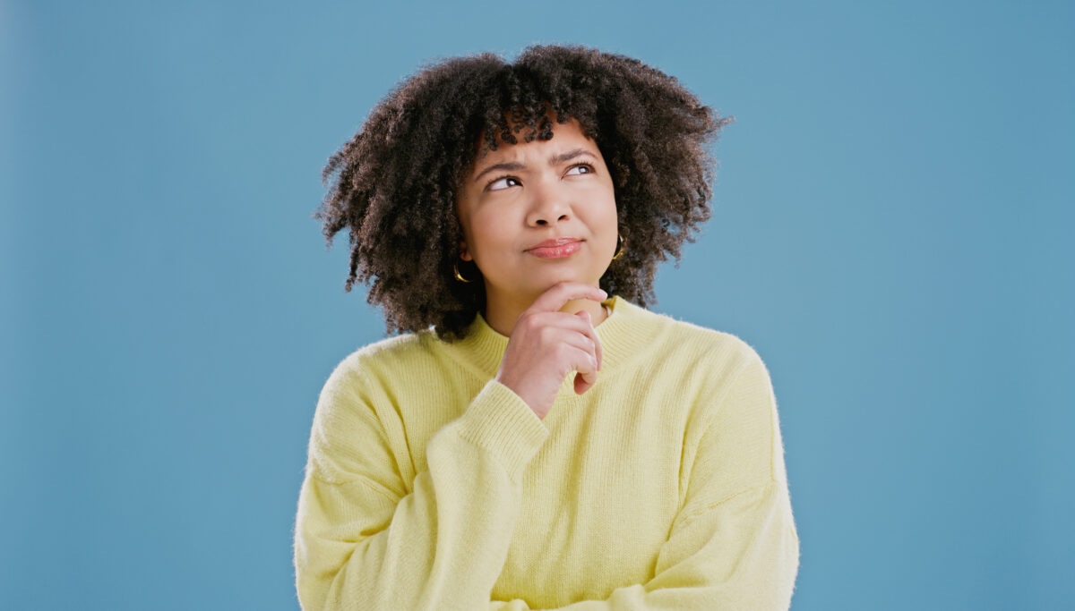 Woman wondering and pensive of idea in studio for decision, doubt and contemplating for choice.