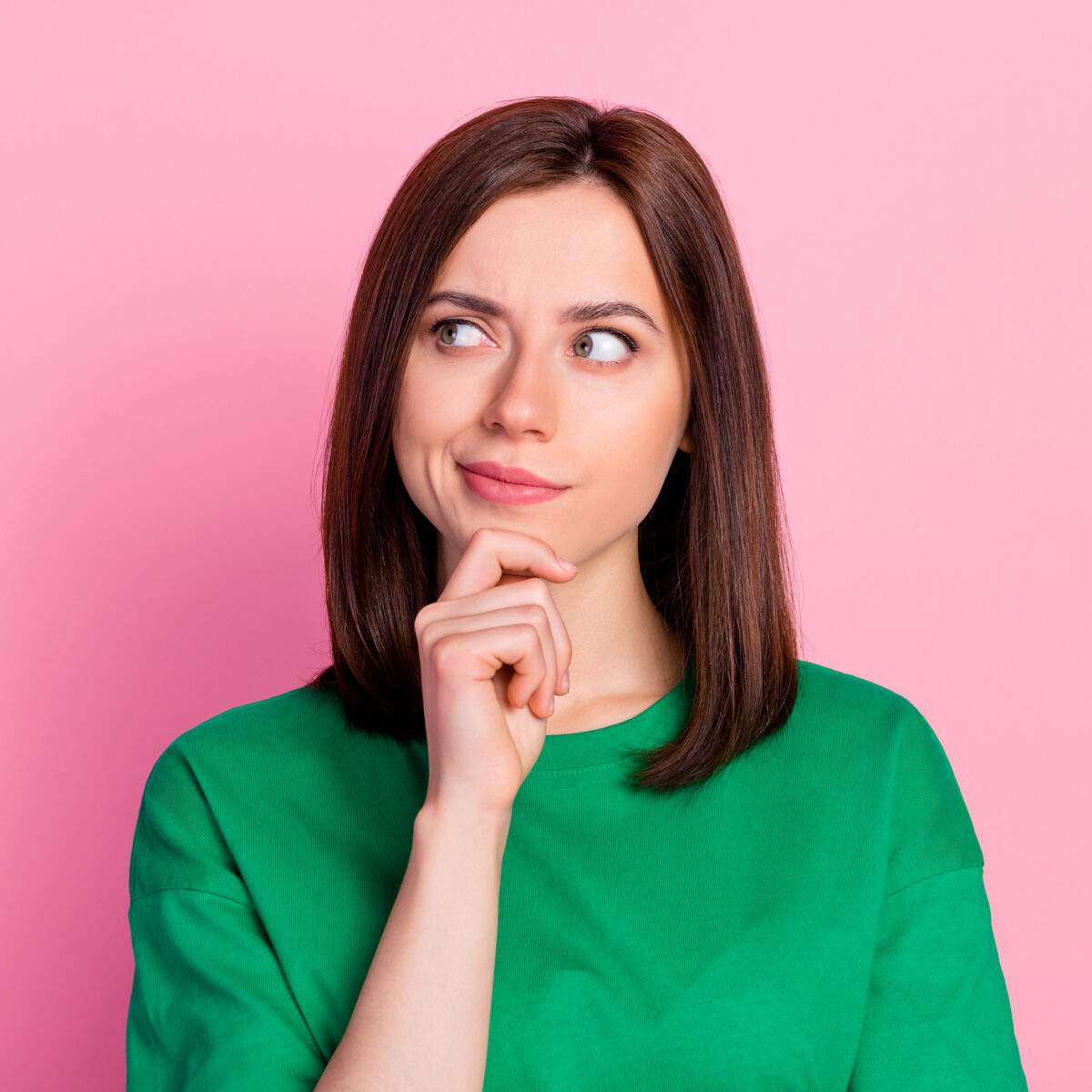 Photo portrait of nice young lady skeptical look empty space not believe doubt dressed trendy green look isolated on pink color background